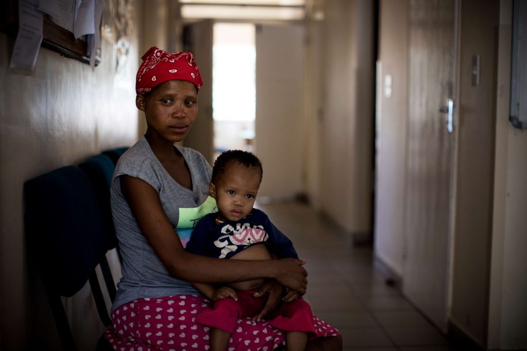 An indigenous San mother waits for her check up at a health centre in a rural Tsumkwe, Namibia.