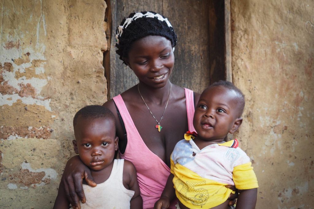 A mother sits with her two young children